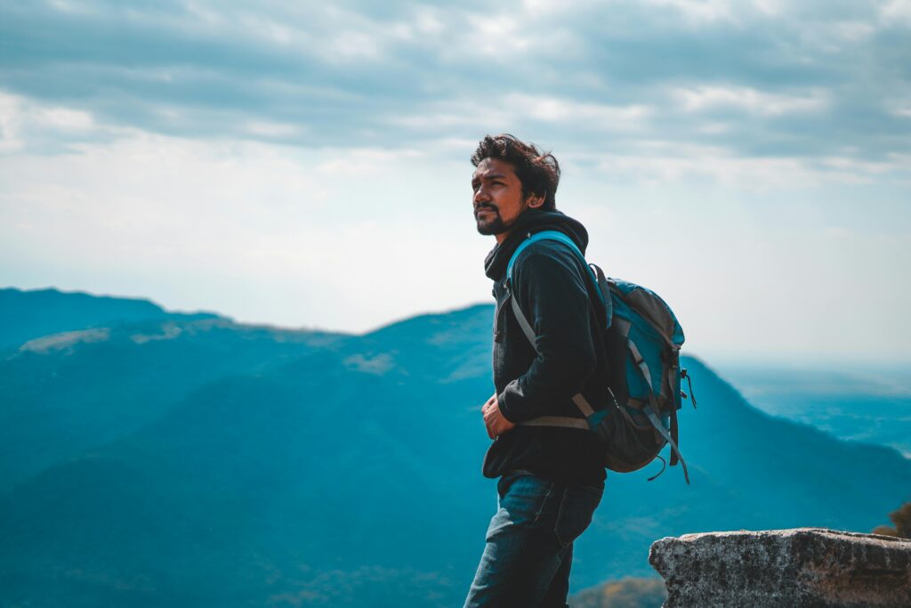 Man enjoying a scenic mountain view in India, capturing the essence of adventure and travel.